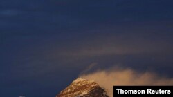 FILE - Light illuminates Mount Everest, during sunset in Solukhumbu District also known as the Everest region, Nov. 30, 2015.