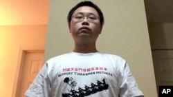 University of Georgia graduate student, Gu Yi poses for a self-portrait wearing a T-shirt with the words “Support Tiananmen Mothers” at his home in Athens, Georgia. Mr. Gu is author of an open letter calling for his compatriots to learn more about the Tiananmen crackdown 26 years ago.