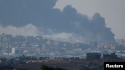 Smoke rises over Gaza following an Israeli strike, after the expiry of a temporary truce between the Middle Eastern nation and Hamas, Dec. 1, 2023.