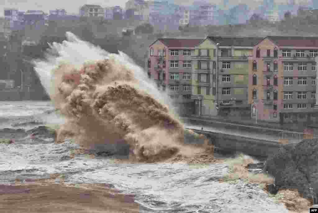 Waves hit a sea wall in front of buildings in Taizhou, China&#39;s eastern Zhejiang province. China issued a red alert for incoming Super Typhoon Lekima, expected to batter eastern Zhejiang province early on Aug. 10.