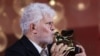 Director Pedro Almodovar poses with his Golden Lion Award for Best Film for the movie "The Room Next Door", during the 81st Venice Film Festival, Italy, Sept. 7, 2024. 