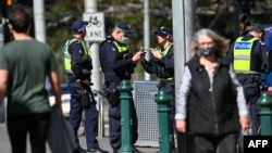 Police patrol a street in Melbourne, Australia, on Sept. 6, 2020, as the state announced an extension to its strict lockdown law while it battles fresh outbreaks of the COVID-19 coronavirus.