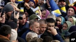 Former Bosnian Army commander of Srebrenica Naser Oric, center, escorted as he leaves court in Sarajevo, Bosnia, Friday, Nov. 30, 2018. 