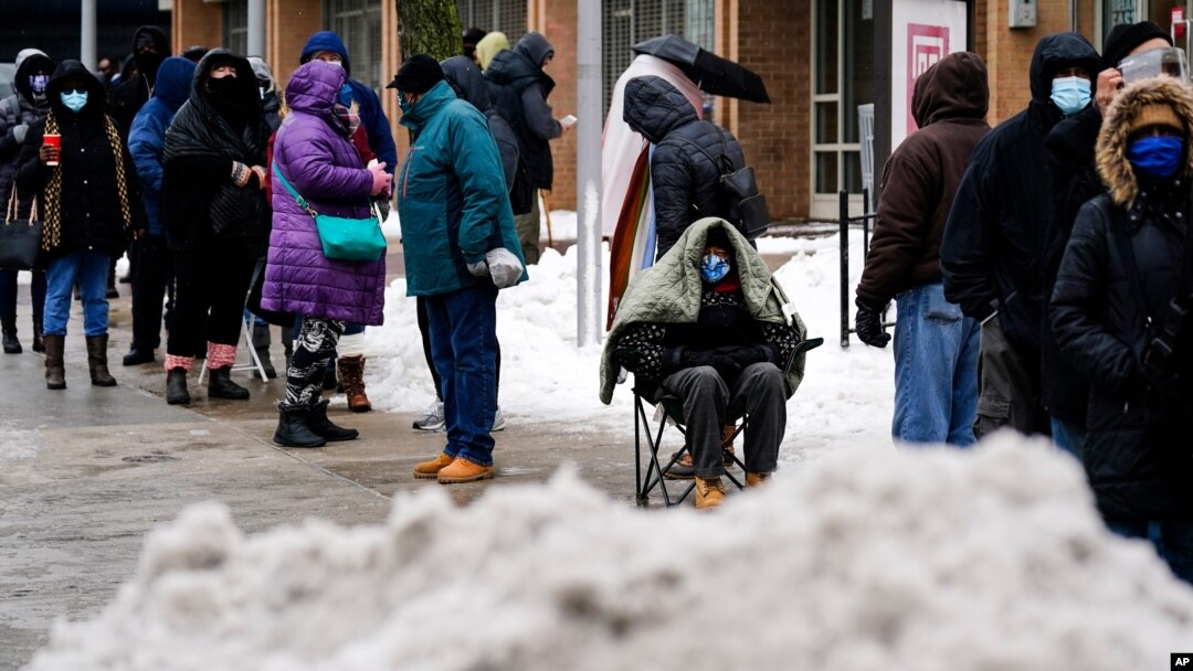 People wait in line for the opening of a 24-hour, walk-up COVID-19 vaccination clinic hosted by the Black Doctors COVID-19 Consortium at Temple University's Liacouras Center in Philadelphia, Friday, Feb. 19, 2021. Efforts to vaccinate Americans…