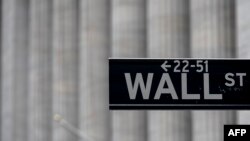 FILE - A Wall Street sign near the New York Stock Exchange is seen in New York City, May 8, 2020.