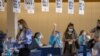 People are processed at the entrance to an empty department store being used as a vaccination center during the outbreak of the coronavirus disease (COVID-19) in Chula Vista, California, Jan. 21, 2021. 