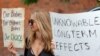 FILE - An anti-vaccine protester holds a sign during a rally outside Houston Methodist Hospital in Houston, Texas, June 26, 2021.