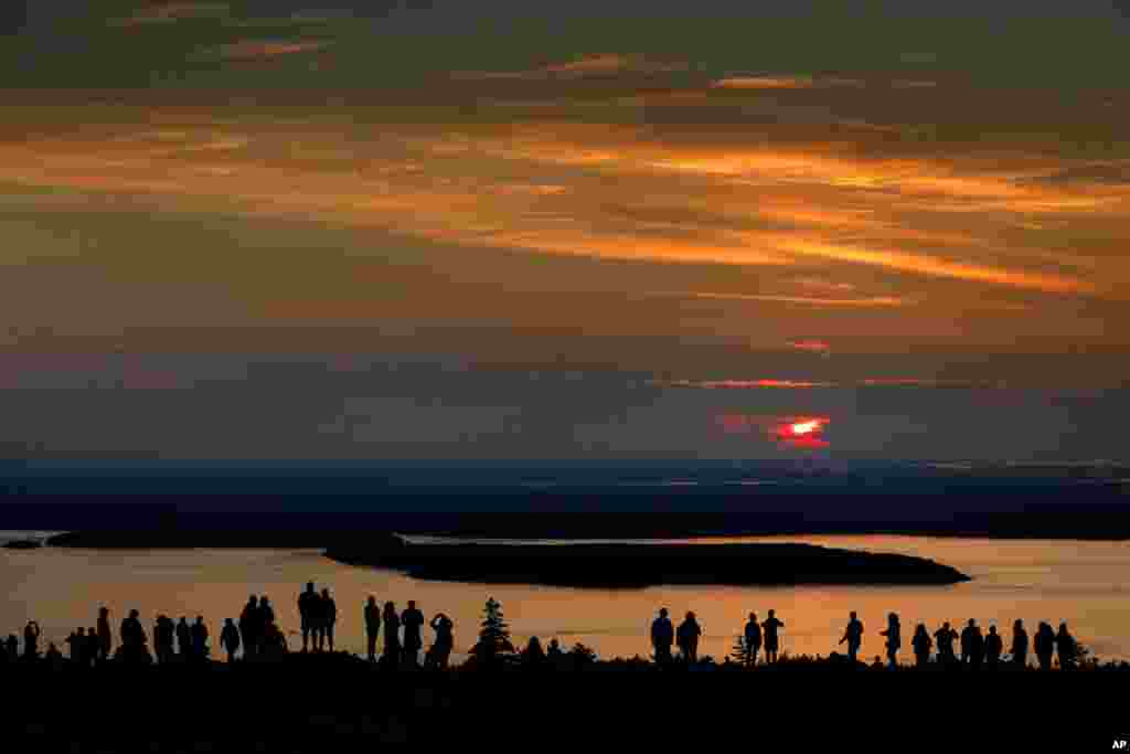 A crowd gathers near the summit of Cadillac Mountain in Acadia National Park to be among the first in the continental United States to see the sunrise, near Bar Harbor, Maine.