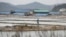 FILE - A man walks through a salt farm on Sinui Island, South Korea, April 3, 2014. A court ruled Sept. 8, 2017, that the South Korean government must pay 37 million won ($33,000) to a man who'd been held as a slave on the salt farm for several years and was stopped from escaping by police. 