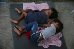 FILE - Migrant children sleep on the floor of a shelter in Nuevo Laredo, Mexico, July 17, 2019.