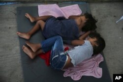 Migrant children sleep on the floor of a shelter in Nuevo Laredo, Mexico, July 17, 2019.