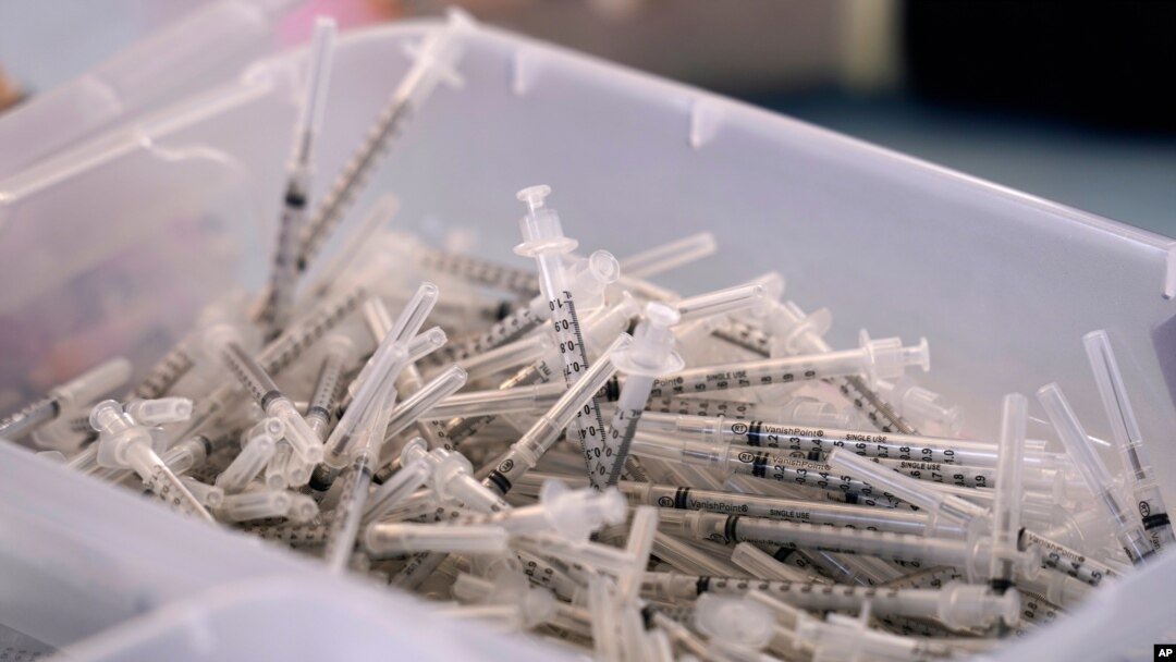 FILE - In this file photo dated Monday, March 29, 2021, A bin of used syringes inside a trailer during a mass vaccination event in Metairie, outside New Orleans, USA.