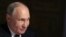 Russian President Vladimir Putin speaks during an interview with Rossiya Segodnya International Media Group Director General Dmitry Kiselev, back to a camera, in Moscow, Russia, Tuesday, March 12, 2024. 