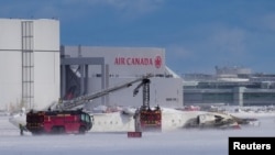 First responders work at the Delta Air Lines plane crash site at Toronto Pearson International Airport in Mississauga, Ontario, Canada, Feb. 17, 2025.