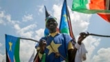 A man waves South Sudanese national flags during peace celebrations in the capital Juba, South Sudan, Oct. 31, 2018. 