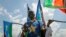 A man waves South Sudanese national flags during peace celebrations in the capital Juba, South Sudan, Oct. 31, 2018. 