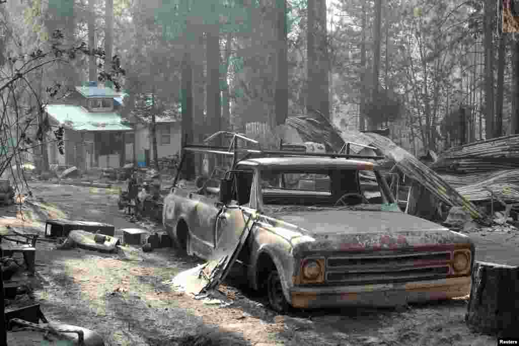 A building and a pickup truck damaged by the Rim Fire in this United States Forest Service handout photo near Yosemite National Park, California, USA.