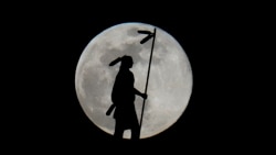 The moon rises in its full stage behind "The Guardian", a bronze, 17 foot statue representation of an American Indian man by Enoch Kelly Haney sitting atop the Oklahoma State Capitol building, Jan. 13, 2025, in Oklahoma City.