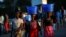 FILE - Women carry baskets with food items on their heads at a market in Blantyre, Malawi, July 10, 2017.