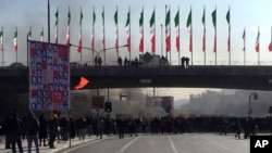 Smoke rises during a protest after authorities raised fuel prices, in the central city of Isfahan, Iran, Nov. 16, 2019.