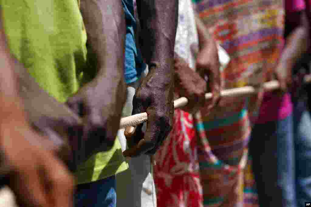 People line up for food aid in Camp Perrin, Haiti, six days after a 7.2 magnitude earthquake hit the area.