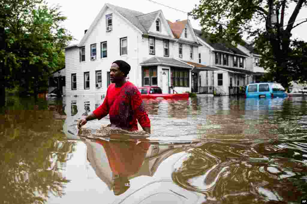 Chris Smith makes his way through floodwaters to the Macedonia Baptist Church in Westville, New Jersey.