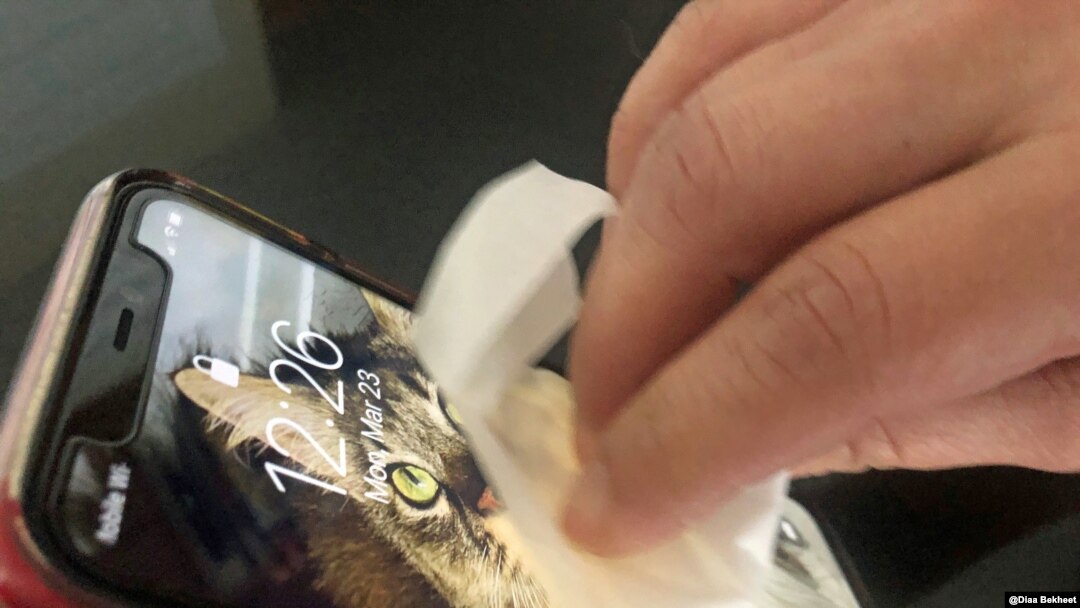 A woman cleans her mobile phone in Virginia, March 23, 2020. (Photo: Diaa Bekheet). The U.S. Centers for Disease Control and Prevention recommends cleaning all "high-touch" surfaces every day, like phones, keyboards and computers. 