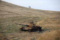 FILE - A view shows a burnt tank near Hadrut town, which recently came under the control of Azerbaijan's troops following a military conflict against ethnic Armenian forces, in the region of Nagorno-Karabakh, Nov. 25, 2020.