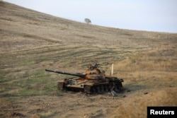 FILE - A view shows a burnt tank near Hadrut town, which recently came under the control of Azerbaijan's troops following a military conflict against ethnic Armenian forces, in the region of Nagorno-Karabakh, Nov. 25, 2020.