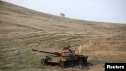 FILE - A view shows a burned tank near Hadrut town, which recently came under the control of Azerbaijan's troops following a military conflict with ethnic Armenian forces, in the region of Nagorno-Karabakh, Nov. 25, 2020.