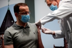 FILE - German Health Minister Jens Spahn receives an influenza injection at Charite hospital, during the coronavirus pandemic, in Berlin, Germany, Oct. 14, 2020. (Reuters)