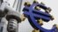 A droplet of water falls from a tap in front of the euro sculpture at the European Central Bank in Frankfurt, Germany, Nov.11, 2011 (file photo).