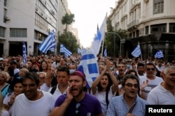Demonstrators shout slogans during a protest against COVID-19 vaccinations, in Athens, Greece, July 24, 2021.