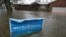 A campaign sign rises above floodwaters as rain continues falling in Norfolk, VA, Oct. 29, 2012.