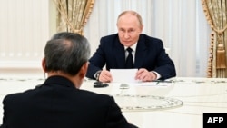 En esta fotografía distribuida por la agencia estatal rusa Sputnik, el presidente de Rusia, Vladimir Putin (derecha), se reúne con el primer ministro del Consejo de Estado de China, Li Qiang, en Moscú el 21 de agosto de 2024.