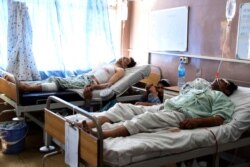 Wounded Afghans lie in bed at a hospital after a bomb attack on a local mosque in Kandahar province, south of Kabul, Afghanistan, Sept. 28, 2019.