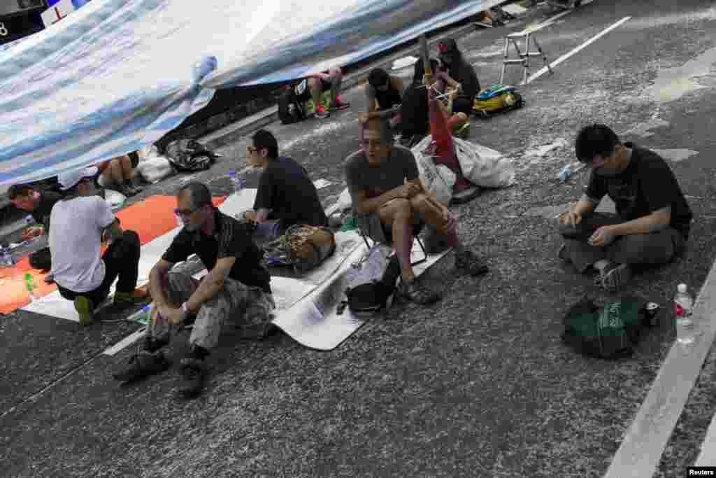 Protesters of the Occupy Central movement rest under a tent on a main road at the Mong Kok shopping district in Hong Kong, October 6, 2014.