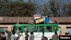 FILE - A bus carrying displaced people arrives at the Tsehaye primary school, which was turned into a temporary shelter for people displaced by conflict, in the town of Shire, Tigray region, Ethiopia, March 14, 2021