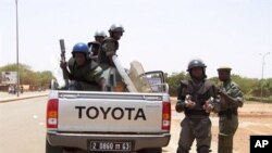 Anti-riot gendarmes prepare during a demonstration by some 300 shopkeepers near the Ouagadougou "Rood Wooko" great market, Burkina Faso, April 16, 2011