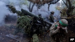 Ukrainian servicemen of Khartia brigade fire a D-30 Howitzer toward Russian positions in Kharkiv region, Ukraine, Oct. 16, 2024.