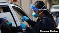 A nurse administers a dose of the Moderna COVID-19 vaccine during the outbreak of the coronavirus disease (COVID-19), in Pasadena, California, January 12, 2021.