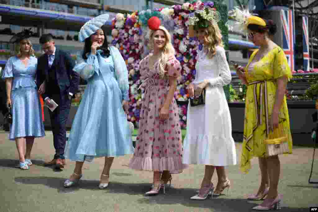 Race-goers attend the first day of the Royal Ascot horse racing meet in Ascot, England.