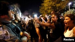 Protesters stand opposite police during a protest for the death of 18-year old Solomon Tekah of Ethiopian descent, after he was shot by police, in Tel Aviv, Israel, July 2, 2019.