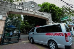 An ambulance enters the main gates of the San Lazaro Hospital in Manila, Philippines, Feb. 2, 2020. The Philippines reported the first death outside of China from the coronavirus, deepening global fears about an epidemic.