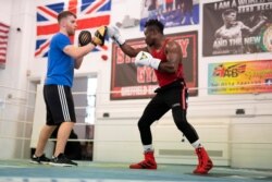 Boxer Thomas Essomba trains with coach Pearce Gudgeon at Steel City Gym in Sheffield, England, Aug. 4, 2021.