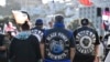 Members of patched gangs gather before marching to parliament during a protest against a proposed law that would redefine the country's founding agreement between Indigenous Māori and the British Crown, in Wellington, New Zealand, Nov. 19, 2024. 