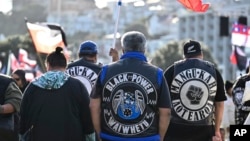 Members of patched gangs gather before marching to parliament during a protest against a proposed law that would redefine the country's founding agreement between Indigenous Māori and the British Crown, in Wellington, New Zealand, Nov. 19, 2024. 