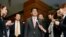 Japan's Prime Minister Shinzo Abe (C) speaks to media after a meeting with cabinet ministers at his official residence in Tokyo, April 12, 2013. (Kyodo)