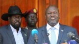 FILE - Former rebel leader Riek Machar, right, and President Salva Kiir address a news conference at the State House in Juba, South Sudan, Feb. 20, 2020.