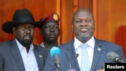 South Sudan's ex-vice President and former rebel leader Riek Machar flanked by President Salva Kiir Mayardit address a news conference at the State House in Juba, South Sudan February 20, 2020. REUTERS/Jok Solomun